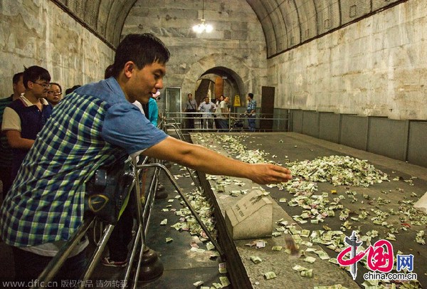 中国网8月15日讯 2014年8月14日，北京昌平区，5A级景区明十三陵定陵地宫内，历史文物上游客祈福所投过去的钱币堆成了小山，没有工作人员制止清理。