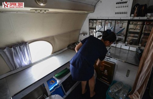 班机的服务区，一名空姐在准备食物。