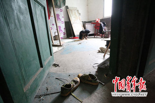 在4兄妹住的三层小楼里，一个房间门口散落着一双运动鞋。 白皓 摄