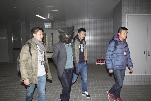 香港警方护送着史德运离开。