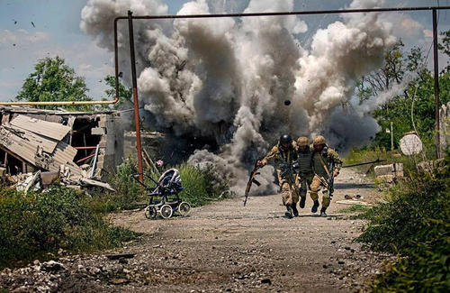 图为两名乌政府军海军陆战队员冒着炮火营救受伤战友，场面酷似战争电影。