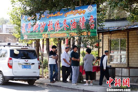 每天前来买馕的人在馕炕前排队?！⊥跣【?摄