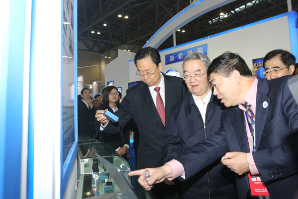 二、桑国卫副委员长（中）在蓝绍敏书记（左一）等领导陪同下在医博会展示区饶有兴趣地参观。摄影／ 顾俊 刘燕