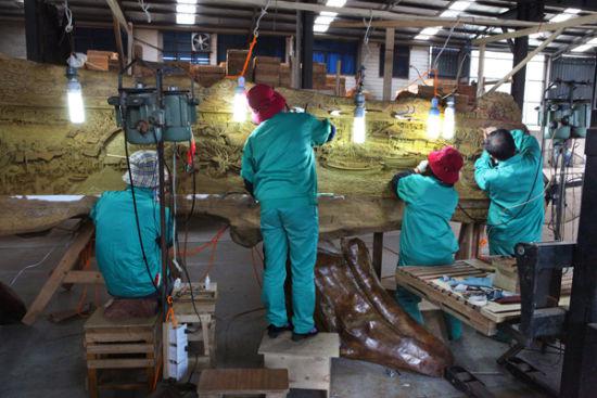 工匠在雕琢金丝楠木“清明上河图”。（胡昌龙 摄）