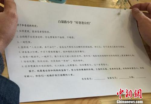 图为家长阅读“好爸爸公约”?！×跤裉?摄