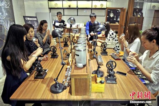 4月27日，顾客在“良食局”内体验自制咖啡。当天，中国第一家购物中心O2O情景式会员体验中心“良食局”在天津大悦城启幕。作为天津大悦城APP中的会员线下实体店，良食局将完成O2O积分消费模式，并通过一系列增值服务，将其打造成为线上线下立体化会员体验平台。顾客可以在店铺内的“粮仓”区体验打粮、装粮的乐趣，“咖啡先生”区可以自己动手做咖啡，“等你来掌勺”的厨房区可以自己动手为朋友们做饭等。<a target='_blank' href='http://www.chinanews.com/'>中新社</a>发 佟郁 摄