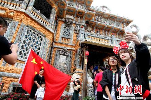 图为游客争相在国旗前合影。　张道正 摄