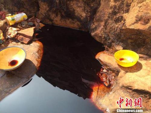 从石崖缝隙里渗出的黑褐色不明液体，从颜色看如酱油状?！×跖?摄