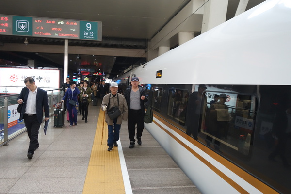 栗大爷在家人搀扶下准备登上G19次“复兴号”高铁