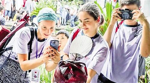 中国侨网海外学子被中国竹编吸引，纷纷拍照留影。 拍友 吴拥军 摄