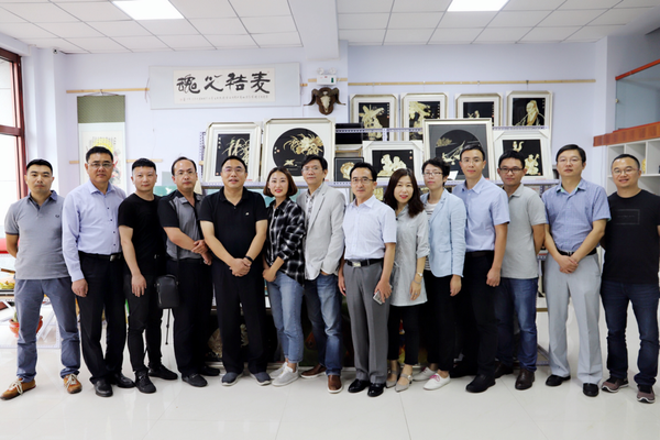 图为：锡林格勒盟盟委委员、行署副盟长曲卫国、人民政协网总经理付鹏、北京时间联席总裁陈朝华、人民网共产党新闻网副总编辑姚奕等媒体领导与麦秸画创作者杨丽丽合影