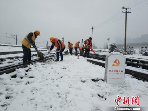 南京东车辆段货车检车员风雪里按标作业，坚守岗位保障运输安全。（刘寅 摄）