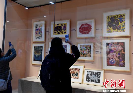 图为《金猪贺岁》展览，观众观看“猪文化”艺术品?！≈芤?摄