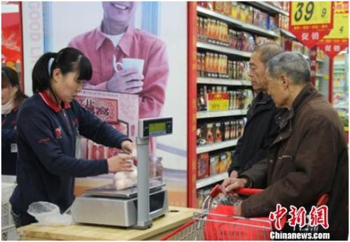 资料图：在保定市北市区一家大型超市内，促销员正在为购买鸡蛋的市民称量、打包。李芳华 摄