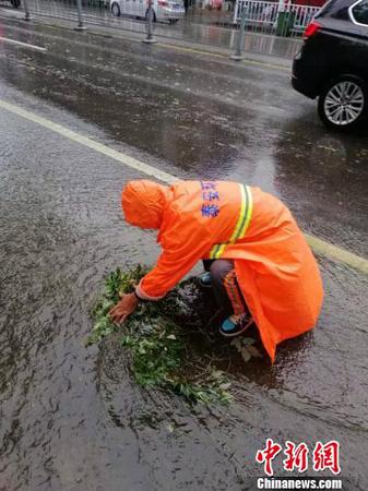 泰安环卫工人清理淤积，保持排水畅通。(泰安全媒体记者供图)