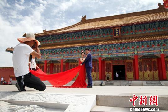 图为新人在兰州新区网红打卡地“长城影视城”拍结婚照?！《】?摄