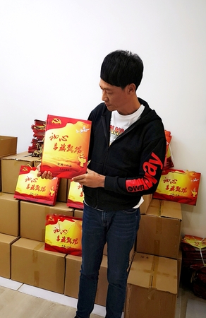 李正白与他编印的《初心 赤旗飘扬》画册