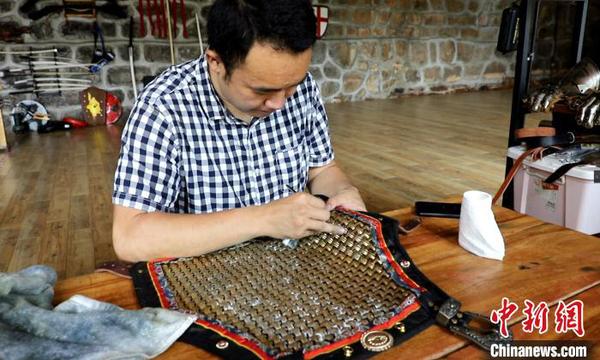 团队成员在修复铠甲。　刘恩权 摄