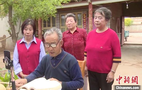 王跃庆低头念唱河西宝卷?！⊥醴?摄