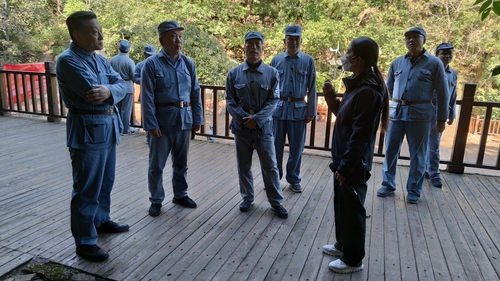 机关干部们听讲解员介绍八路军英勇抗战的历史故事