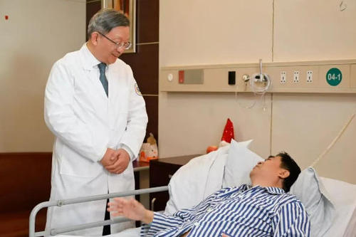 蔡秀军在查房时与患者交流。