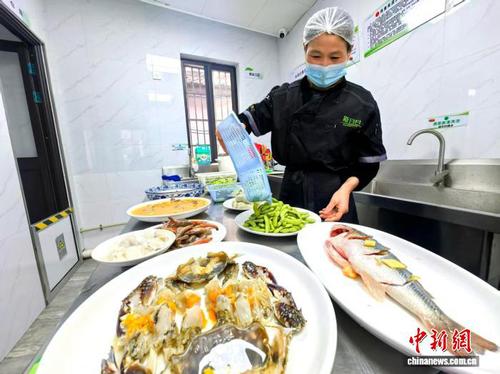 近日，社区“全龄食堂”的工作人员备菜。(甬江街道供图)